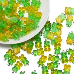 Macro detail of translucent resin gummy bear charms with green yellow gradient and silver loop