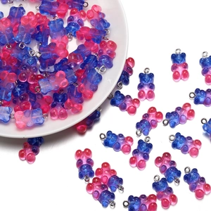 Macro detail of royal blue and rose red gradient resin bear charms for DIY jewelry