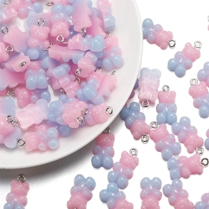 Close-up of pink and blue gradient resin gummy bear charms with silver metal eyelet hooks