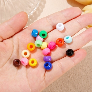 Colorful acrylic large hole bucket beads held in hand for DIY handmade jewelry crafts