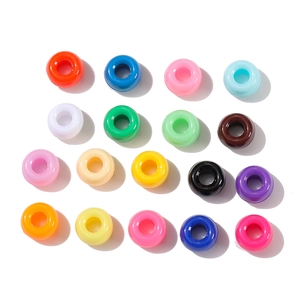 Macro detail of 20 colorful acrylic barrel beads with large holes for DIY jewelry making
