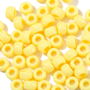 Macro shot of bright yellow acrylic large hole beads for DIY necklace making projects