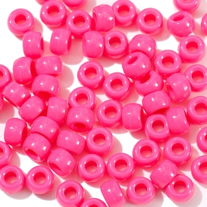 Macro detail of hot pink acrylic pony beads with smooth finish for DIY jewelry crafts