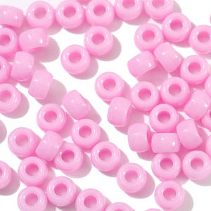 Macro shot of smooth pink acrylic pony beads with large holes for DIY jewelry making