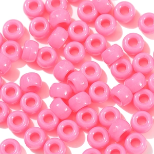 Macro shot of smooth pink acrylic pony beads with large holes for DIY jewelry making
