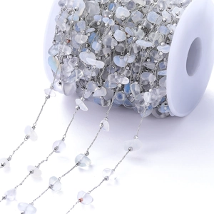 Close-up of bohemian style natural white stone chain on spool for DIY jewelry making