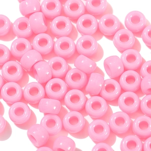Macro detail of glossy pink acrylic pony beads for DIY jewelry and crafts making