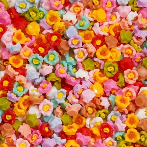 Vista macro de dijes de resina de 6mm con forma de camelia para uñas en colores mixtos