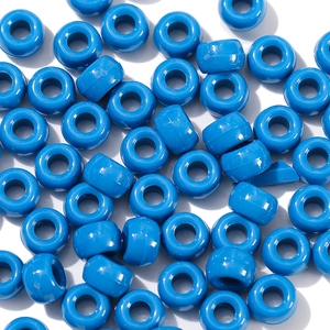 Macro shot of Klein blue acrylic barrel beads for DIY jewelry and necklace making