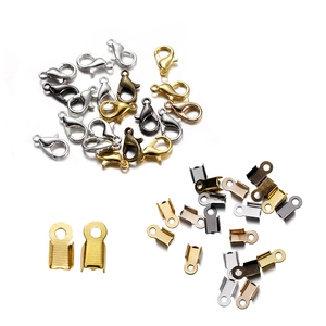Detailed display of assorted metal lobster clasps and cord end tips in various colors