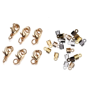 Close-up of golden lobster clasps and multicolor cord end caps for DIY jewelry making