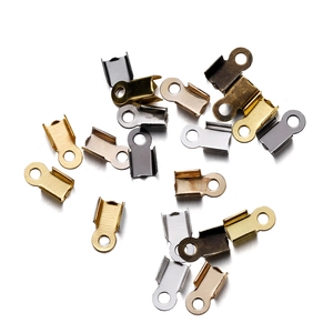 Assorted DIY jewelry end crimp beads in gold, silver, bronze, and black metal finishes