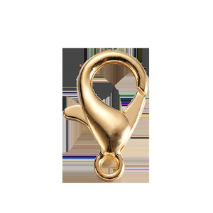 Detailed macro of gold-plated lobster clasps and jump rings for DIY jewelry making