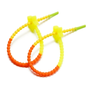Detail showing two orange gradient star-shaped silicone cable ties and bag accessories