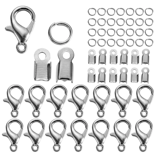 Flat lay detail of DIY jewelry kit with silver lobster clasps, jump rings and cord ends