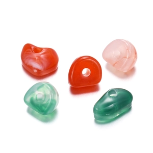 Macro shot of 5-8mm colorful acrylic beads with vertical holes for DIY crafts