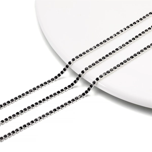 Close-up of 2mm silver tennis chain with black rhinestones in a four-prong setting