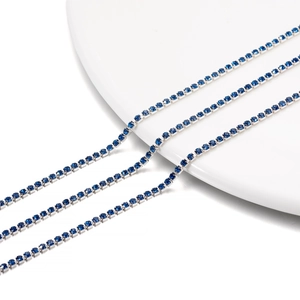 Macro shot of 2mm dark blue rhinestone tennis chain with silver metal claw setting