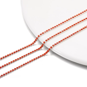 Close-up of 2mm orange-red rhinestone chain with silver metal base for DIY jewelry making