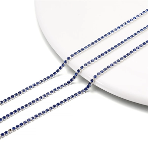 Detailed view of 2mm silver-plated claw chain with dense deep blue rhinestones