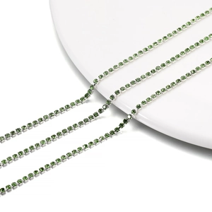 Close-up of 2mm green crystal rhinestone claw chains with silver base for DIY crafts