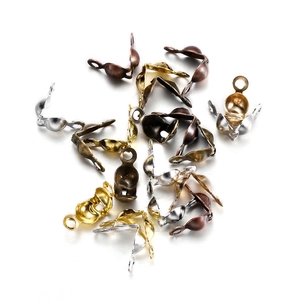 Detail of multi-color metal crimp bead covers for jewelry making in silver and gold