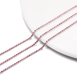 Macro shot of 2mm pink crystal rhinestone claw chain with silver plating for DIY crafts