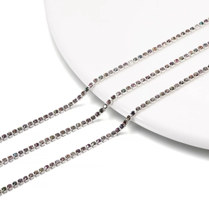 Macro detail of 2mm rainbow rhinestone tennis chain with silver-tone four-claw settings