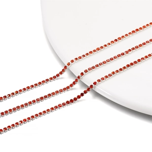 Close-up of 2mm silver-plated chain with densely set red rhinestones for DIY crafts