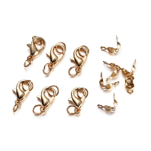 Macro view of gold plated lobster clasps and folding crimp connectors for jewelry making