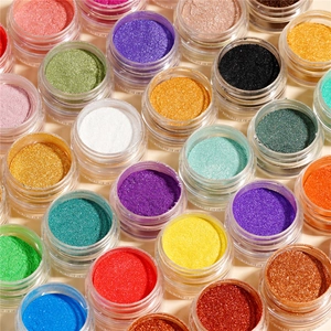 Top-down view of colorful pearlescent nail glitters and DIY resin pigment powders