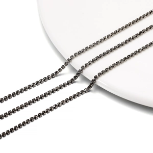 Macro detail of 2mm dark grey rhinestone claw chains for DIY jewelry making and crafts