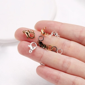 Macro shot of lobster clasps and jump rings set for DIY jewelry making in various metal finishes