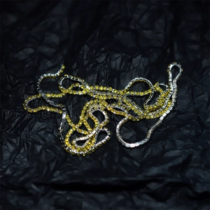 Macro shot of 2mm yellow rhinestone claw chain with silver metal base for DIY jewelry making