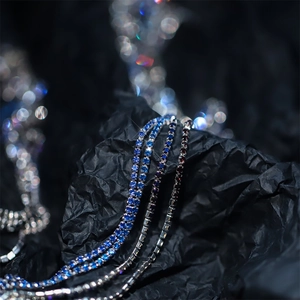 Macro shot of 2mm colorful rhinestone tennis chains in bright blue and black tones