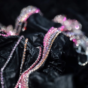 Close-up of 2mm colorful rhinestone claw chain with pink and purple gradient crystals