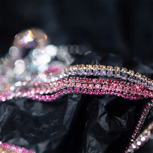 Macro detail of 2mm multi-color rhinestone claw chains for DIY jewelry making