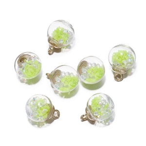 Close-up of luminous glass ball pendants with star sequins for DIY jewelry making