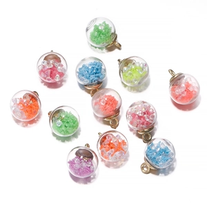 Detailed view of colorful luminous glass ball pendants with sequins for DIY jewelry making