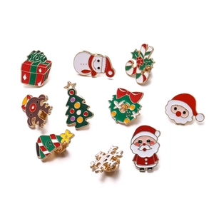 Close-up of 10-piece Christmas enamel pins including Santa, reindeer, and snowman