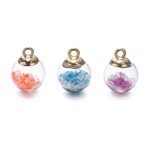 Close-up of three DIY glass globe pendants with colorful sequins and gold loops