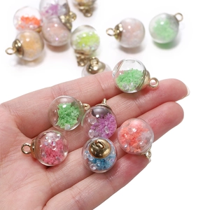 Macro shot of colorful luminous glass ball pendants with sequins for DIY jewelry