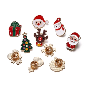 Detail of colorful enamel Christmas brooches featuring Santa, reindeer and snowman designs