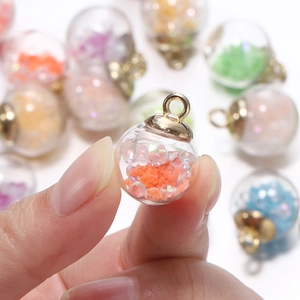 Luminous glass ball charms with colorful sequins and golden metal loops for DIY jewelry