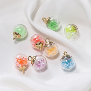 DIY glowing glass ball charms with colorful sequins and golden caps in multiple colors