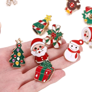 Close-up of colorful Christmas enamel pins with reindeer, tree and snowman designs