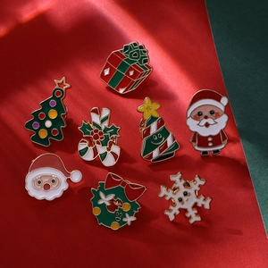 Detail of colorful Christmas enamel pins featuring Santa Claus, snowman and tree motifs