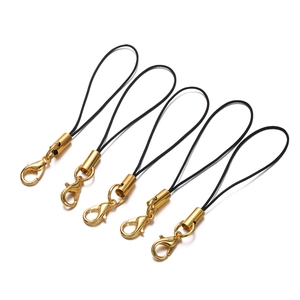 Detail of gold lobster clasps with black nylon cords for DIY phone jewelry accessories