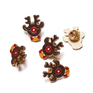 Detail of Christmas reindeer enamel brooch with red nose and gold butterfly clutch back