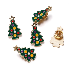 Detailed macro view of five enamel Christmas tree pins with colorful dots and butterfly clasps